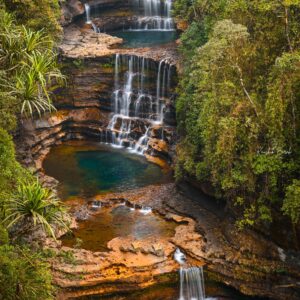 Discover the breathtaking beauty of Meghalaya's cascading waterfalls amidst lush greenery.